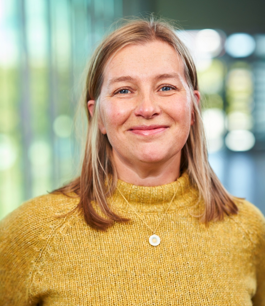 Porträttfoto av Ulla Janson i gul tröja.