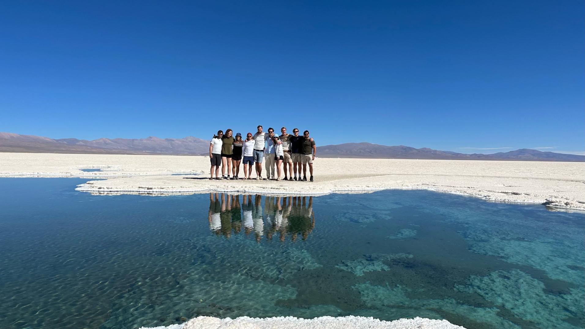 A group of exchange students together by a lake. Photo.
