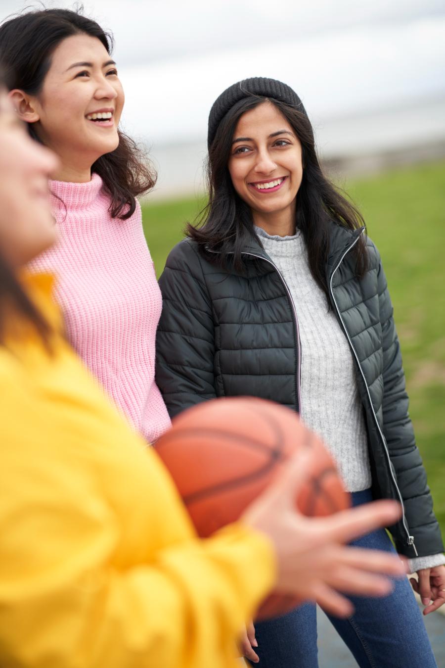 Three female students are laughing together. Photo.