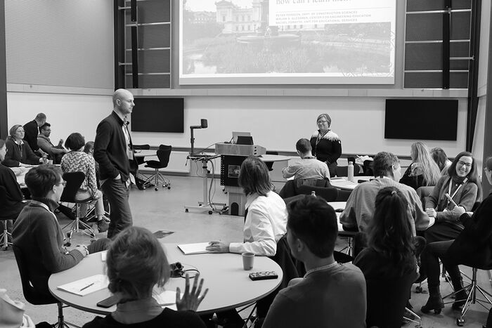 People in a hall listening to a lecture. Photo.