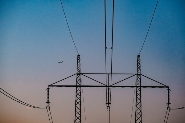 High voltage wires under a blue evening sky.