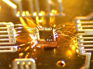 The chip in the middle of the picture, is 0.9 mm times 0.9 mm.