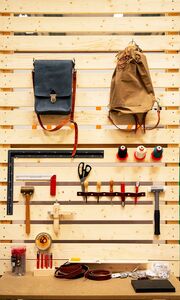 Tools hanging on a wooden wall. Photo.
