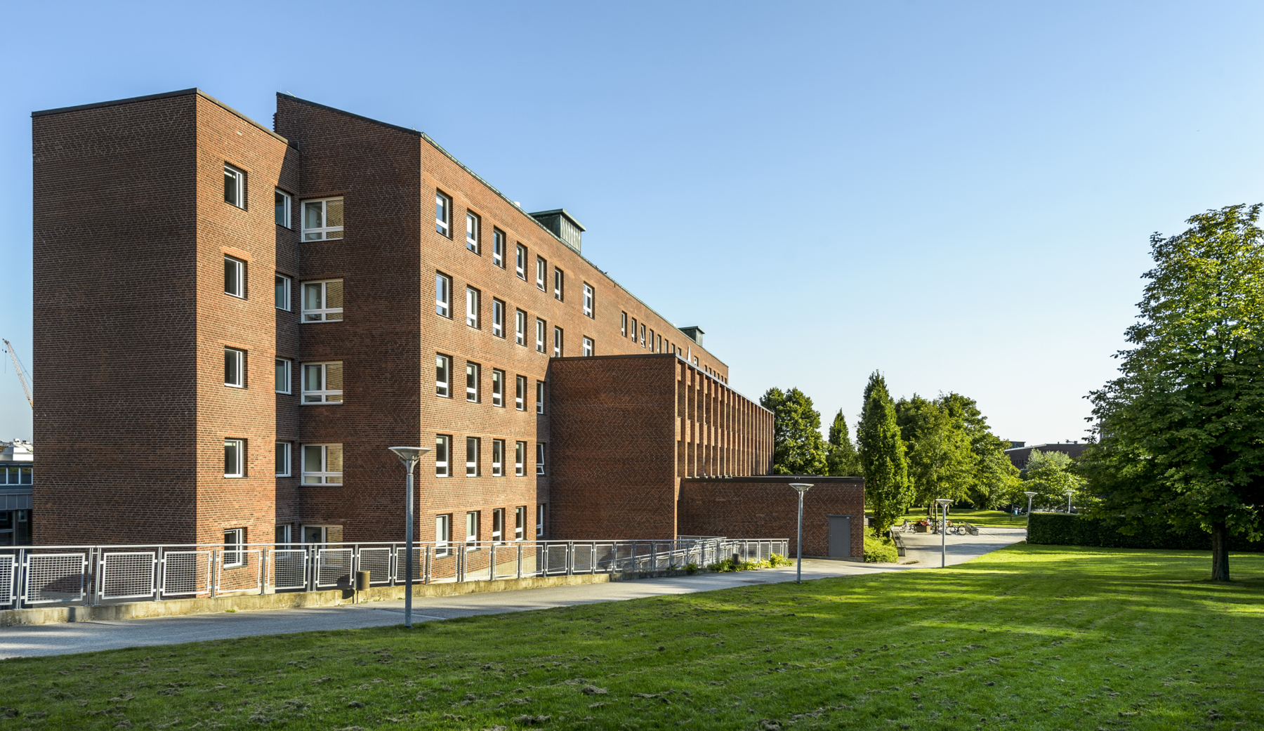 A-huset, a red brick building, at LTH campus, with green grass in front.