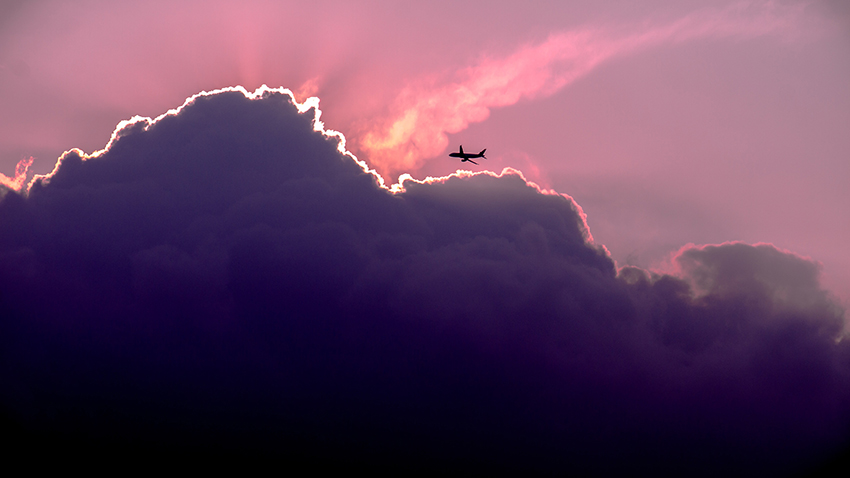 Airplane flying in the clouds. Photo.