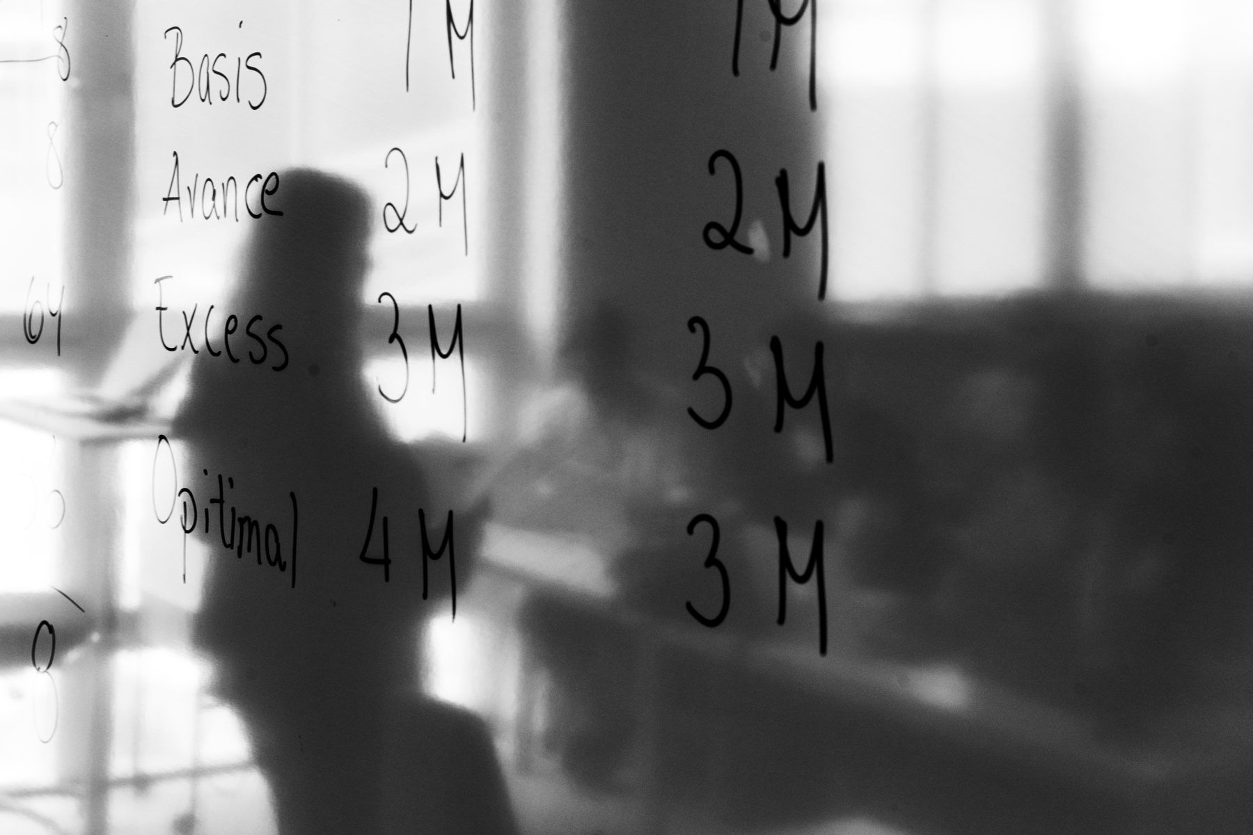 A person mirroring in a white board board. Photo.