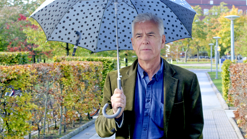 Rolf Larsson med ett paraply. Foto.