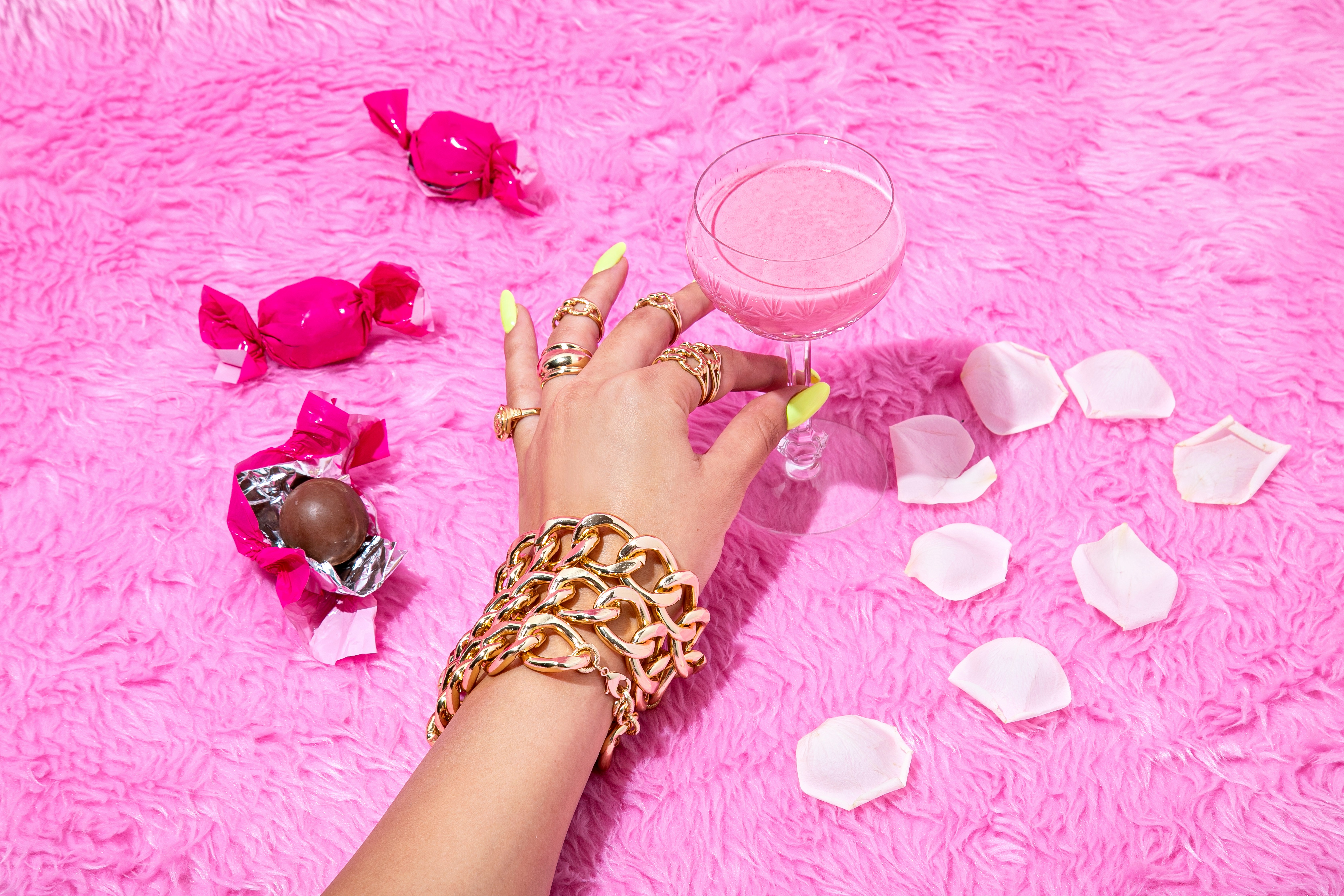 A jeweled hand reaching for a glass. Photo.