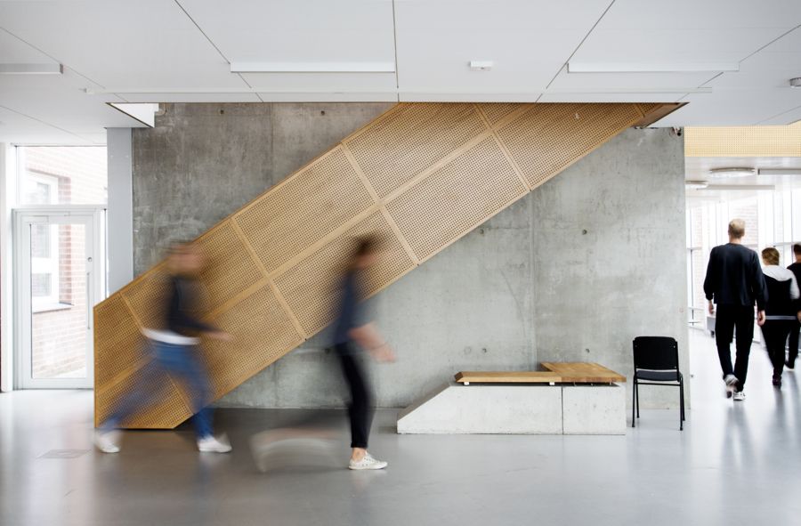 People moving in front of a stairs. Photo.