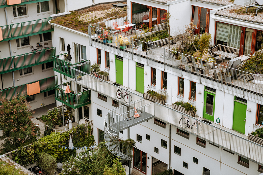 Apartment building with lots of greenery. Photo.
