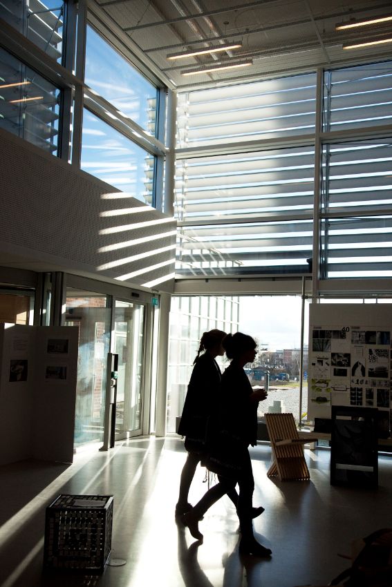 Students walking through a university building. Photo.
