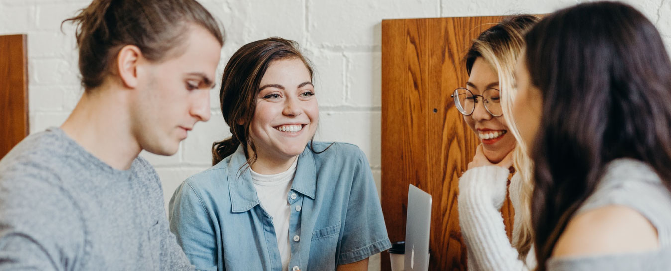 four students socialising. photo: unsplash.